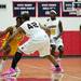 Ypsilanti senior Justin Bernard drives into the body of Saginaw High player on Tuesday, March 19. Daniel Brenner I AnnArbor.com